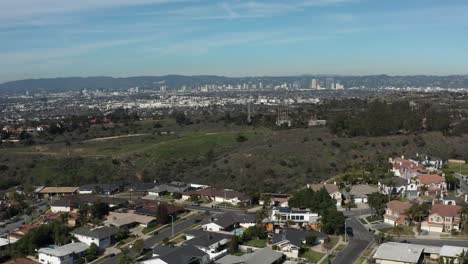 Toma-Aérea-De-Un-Parque-Con-El-Centro-De-Los-Ángeles-Al-Fondo