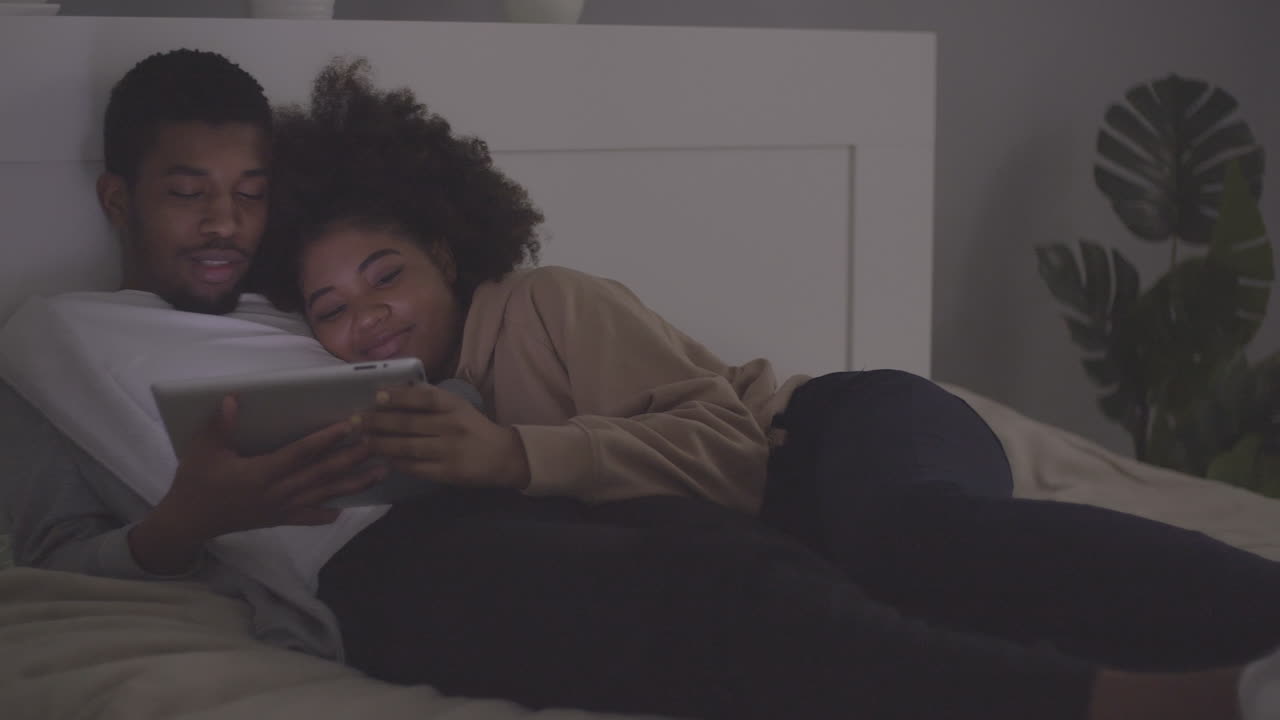 Young Couple Watching A Movie On The Tablet