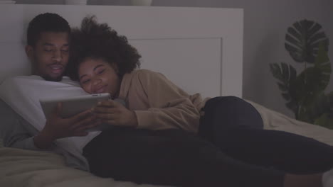 young couple watching a movie on the tablet