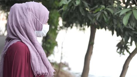 woman wearing hijab and mask outdoors