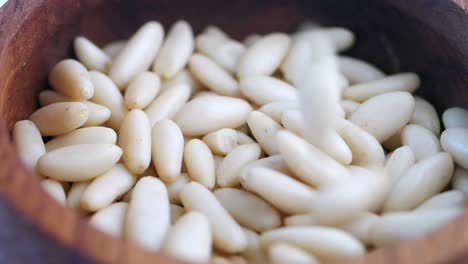 pine nuts in wooden bowl