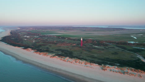 Sand-Dune-Beach-With-Vintage-Red-Brick-Lighthouse-In-Westhoofd,-Ouddorp,-South-Holland,-Netherlands