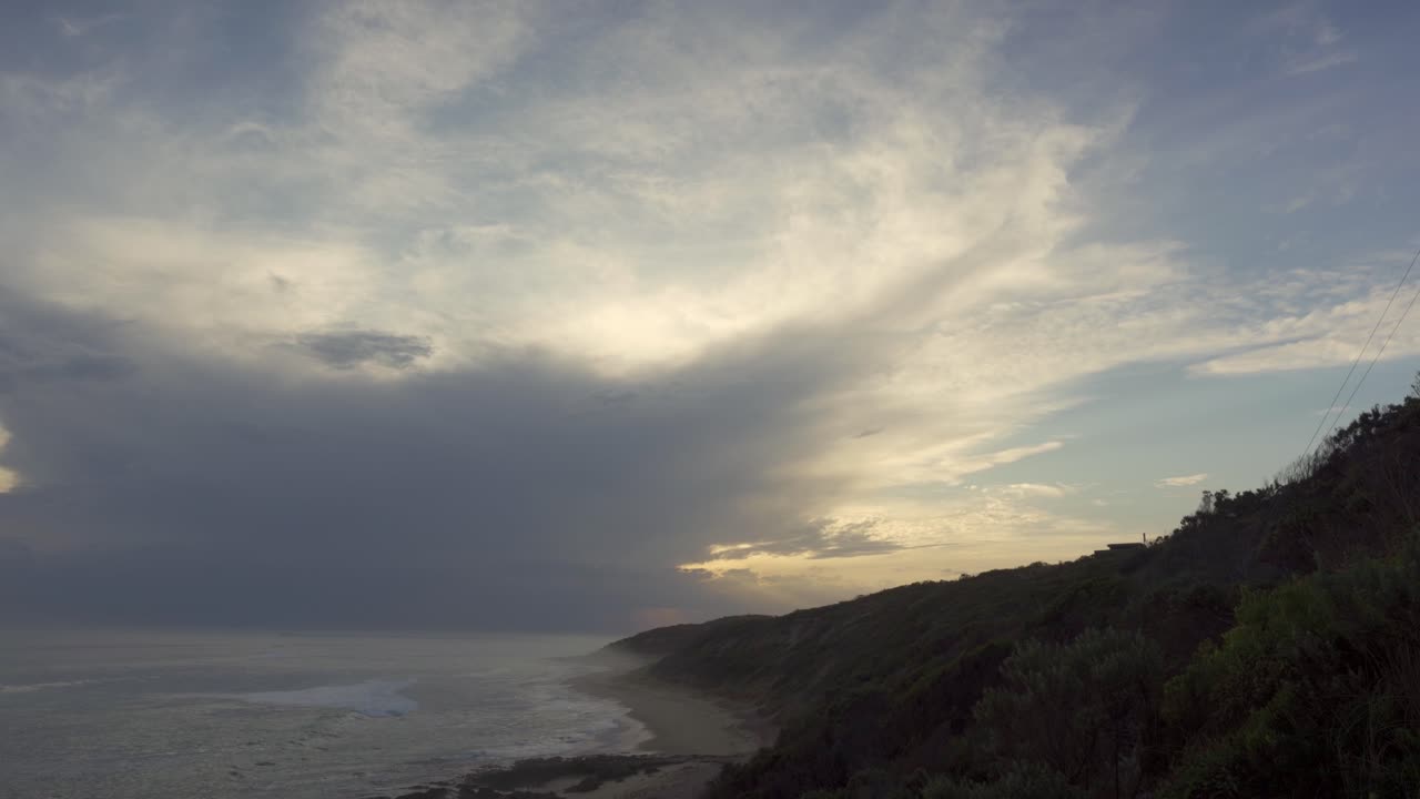 Dramatic backlit clouds and ocean swells along Point Lonsdale back beach on the Bellarine Peninsula in Victoria Australia