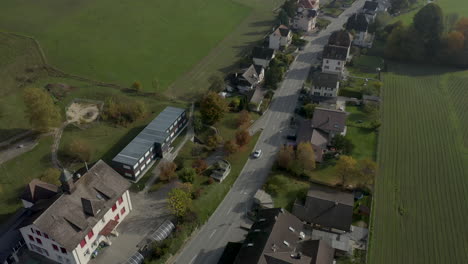 Aerial-view-of-a-car-driving-through-a-village