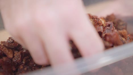 sun dried tomatoes in plastic container as ingredients for cooking