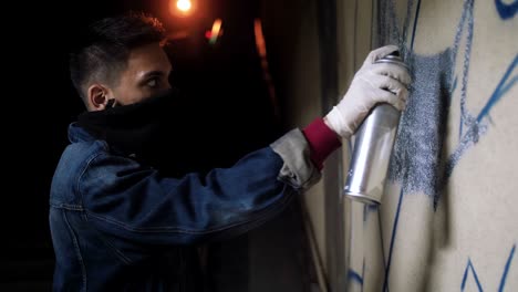 graffiti artist painting on the wall in subway