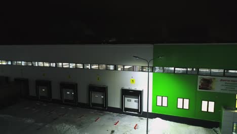 storehouse building with closed ramp gates at winter night