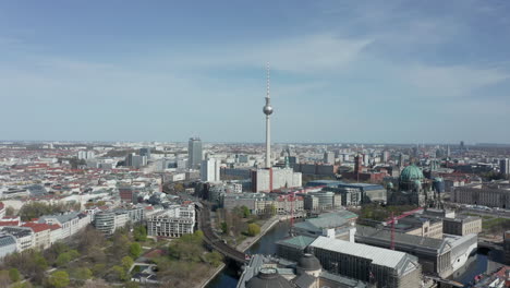 AERIAL:-Super-Close-Up-View-of-the-top-of-Alexanderplatz-TV-Tower-in-Berlin,-Germany-on-hot-summer-day