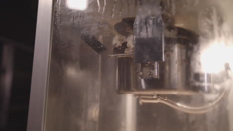 pop corn being made in a classic pop corn machine filmed in slow motion - ungraded