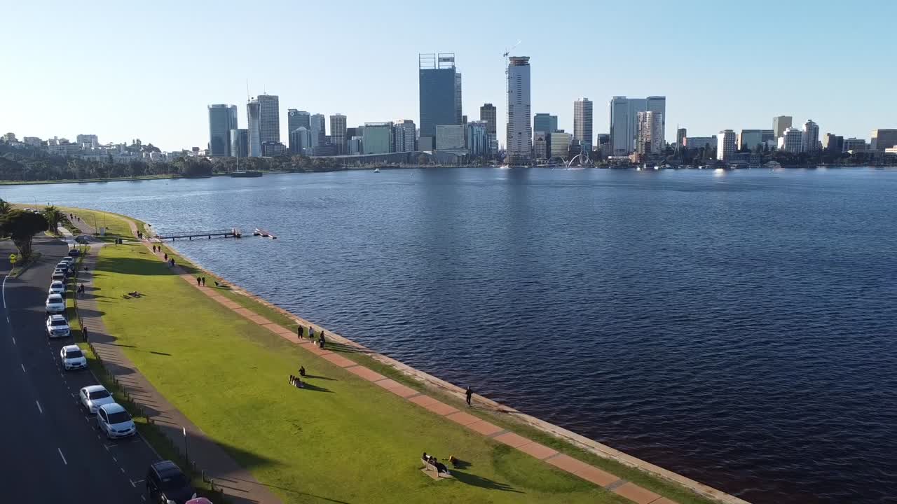 Drone shot rising over Swan River with skyline of Perth, Western Australia and South Perth foreshore