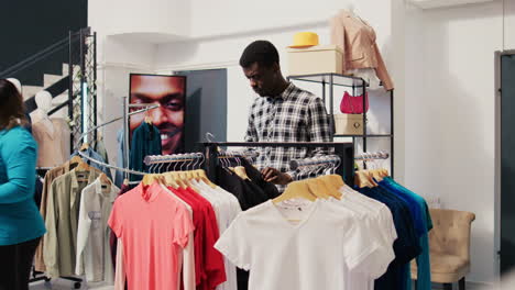 man checking rack with new collection