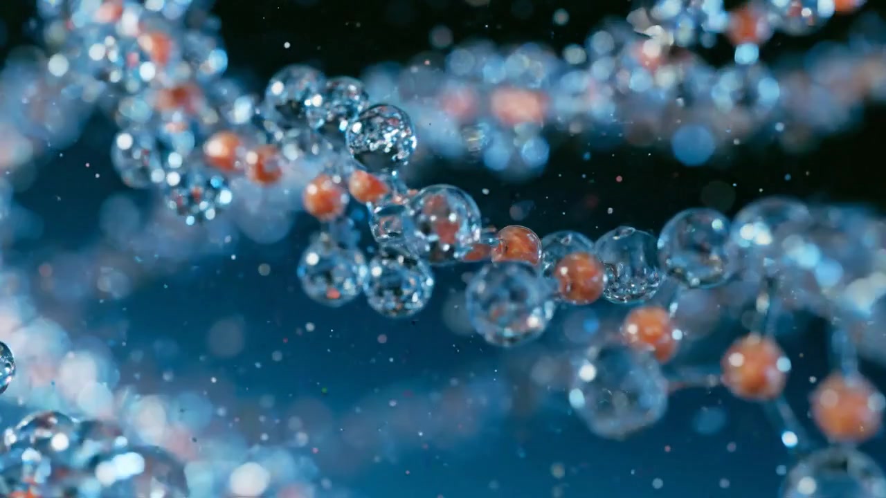 Blue and orange molecular clusters floating in a microscopic environment