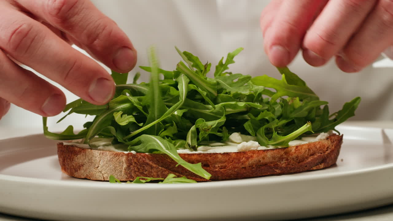 Preparing a delicious arugula and cream cheese toast