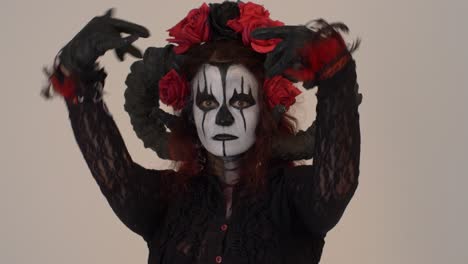 catrina cosplay girl seducing you with her eyes and hands in a light background, medium close up