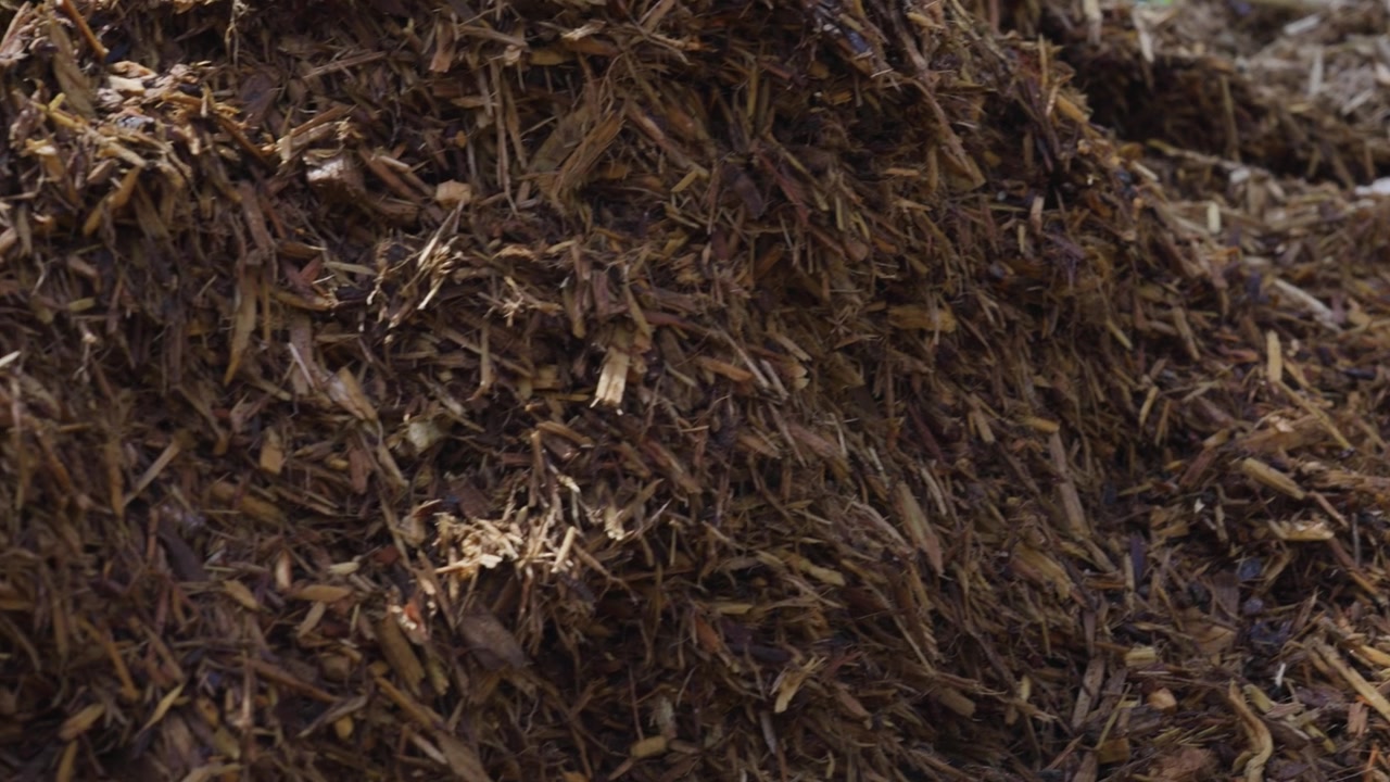 Close up look while panning left across a Mulch Pile.