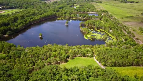 Backwards-aerial-footage-of-the-Cattana-Wetlands-at-Smithfield,-near-Cairns,-Queensland,-Australia