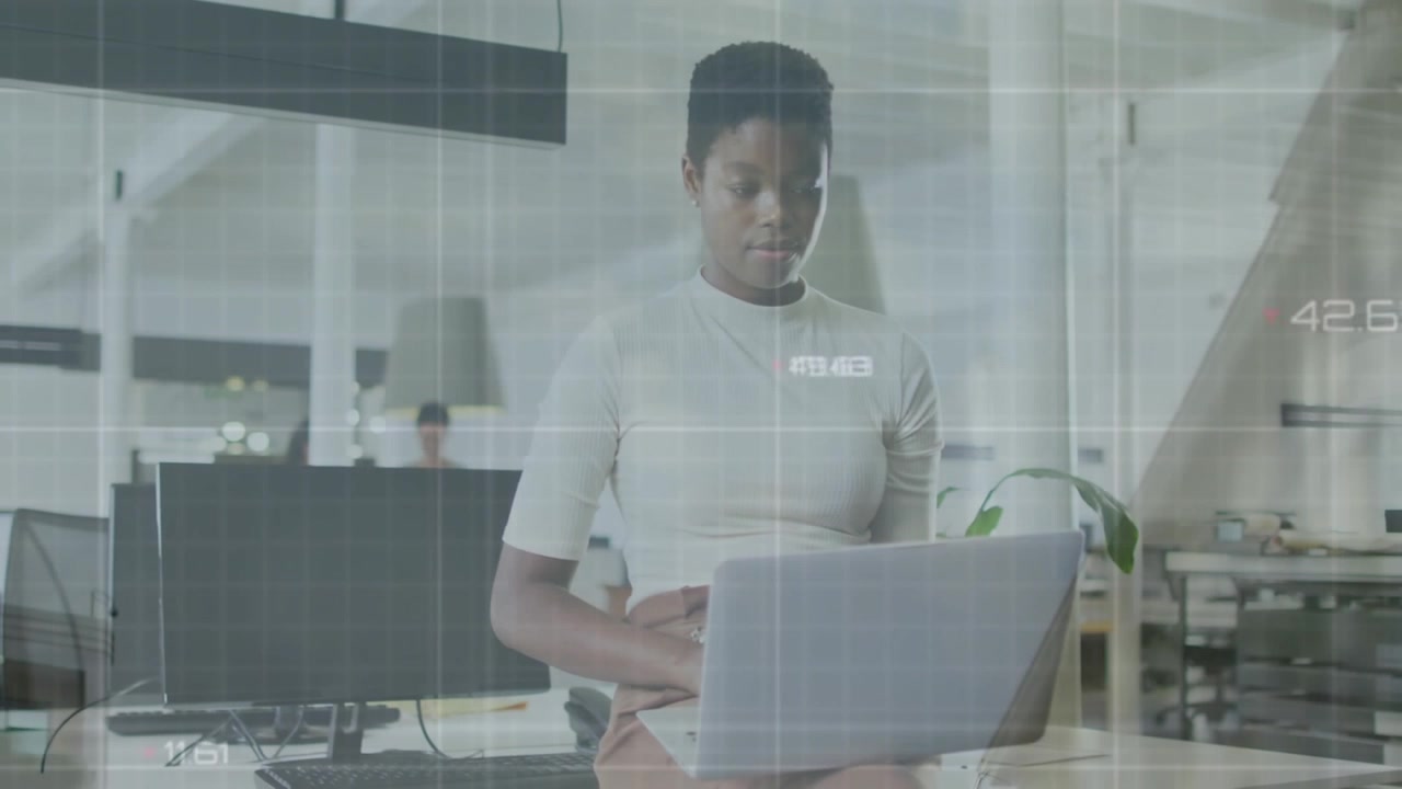 Animation of data processing against african american woman using laptop at office