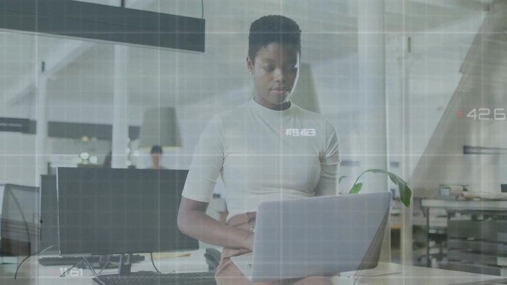 Animation of data processing against african american woman using laptop at office