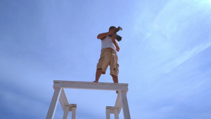 Professional photographer with camera on sky background