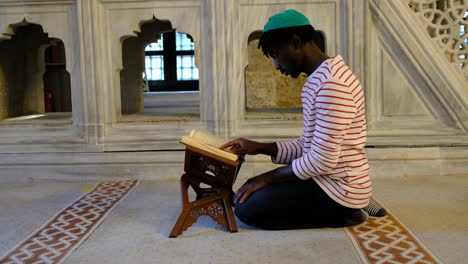 reading holybook in mosque