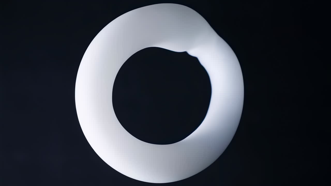 Abstract White Smoke Ring Dissipating on a Dark Background