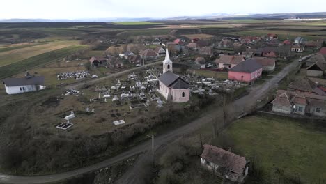 aerial shot around a church over a poor village