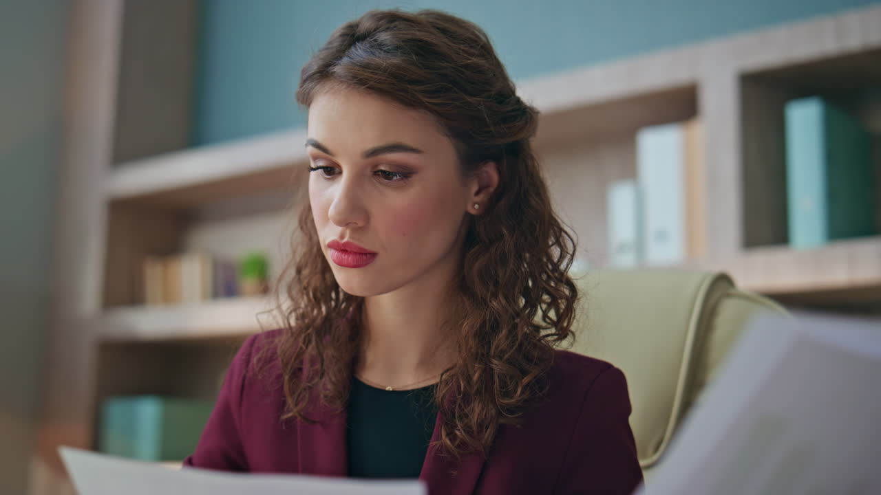 Focused boss checking documents in company office closeup. Young professional