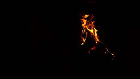 burning bonfire inside the fireplace at home. flaming blaze at night. orange flame inside the fireplace