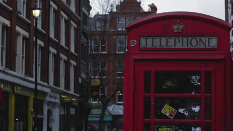 closeup of an old historic red telephone booth in london. the typical symbol phone booth of the united kingdom and england. a red phone booth outside of london street. a red telephone booth in london.