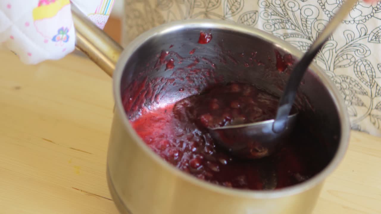Mid-section of senior woman preparing jam