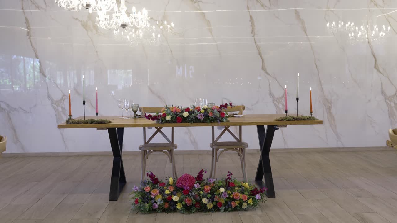 wedding table for two with colorful flowers and soft candlelight decor