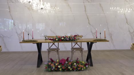 wedding table for two with colorful flowers and soft candlelight decor