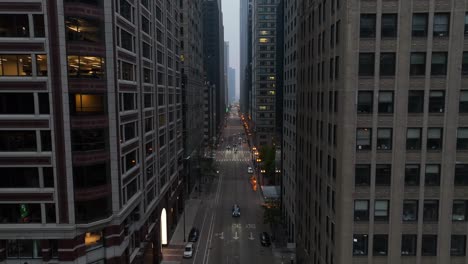 large city with tall skyscrapers on both sides of downtown street