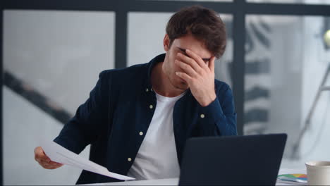 close-up view of upset businessman finding mistakes in documents