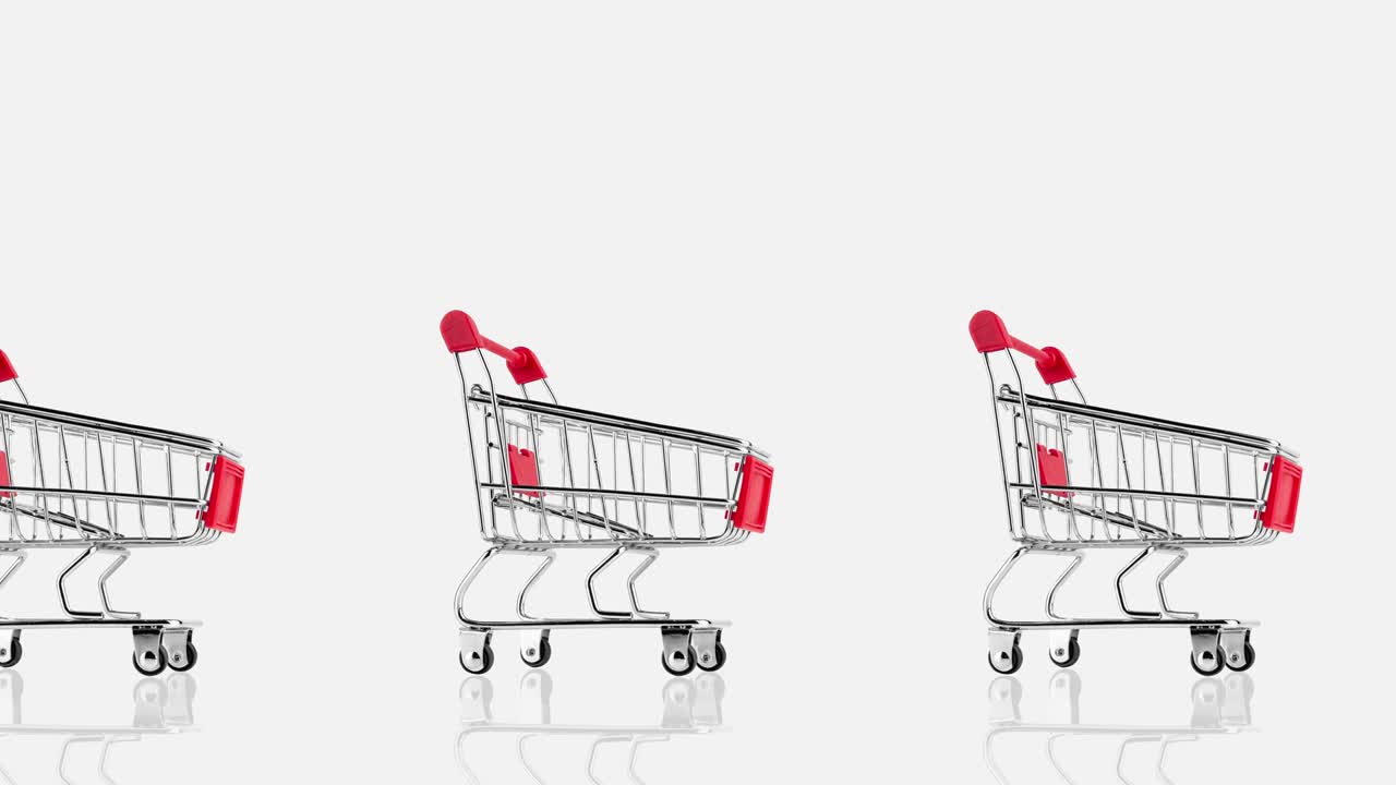 seamless looping animation with many empty metallic shopping carts of red color against gray background, side view, copy space