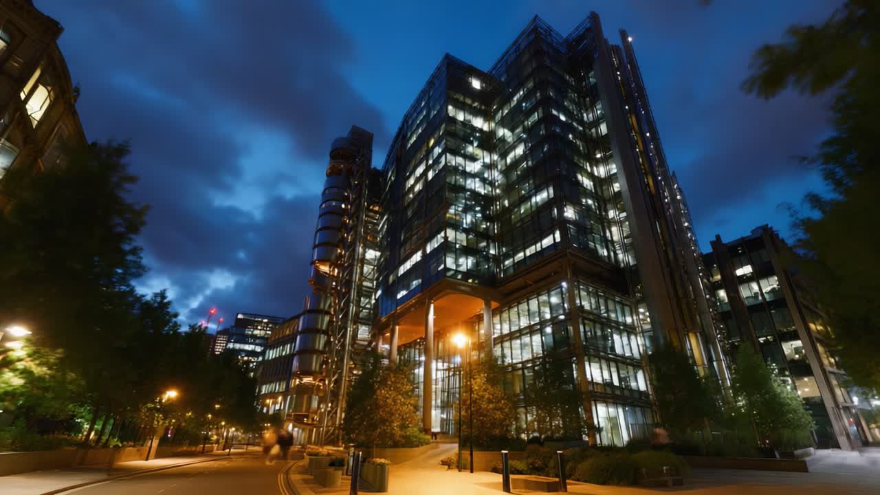 Maravilhas arquitetônicas modernas: uma vista noturna deslumbrante de um imponente edifício de vidro com luzes brilhantes refletindo em um céu noturno profundo e ambiente urbano