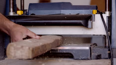 a wood planer smooths out a piece of timber