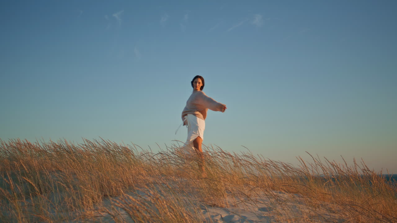 Happy brunette walking sunny nature enjoying summer wind. Young woman spinning