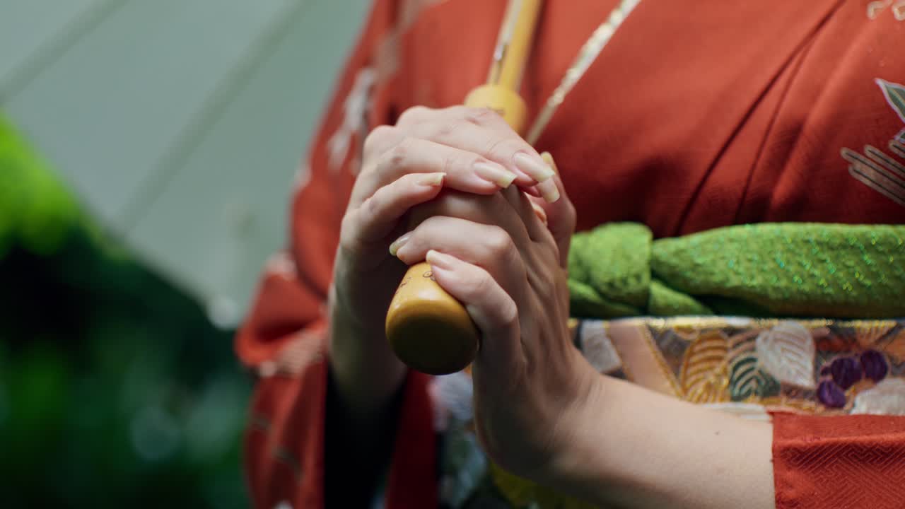 Woman in Kimono Holding Umbrella Handle