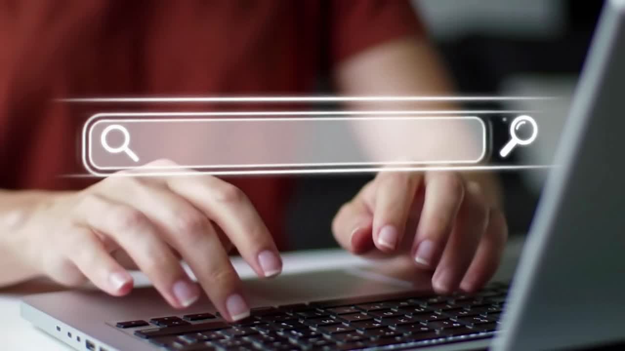 Person Using a Laptop with a Virtual Search Bar to Find Online Content