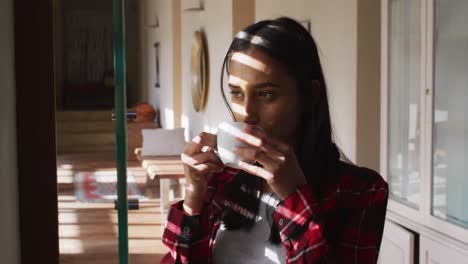 mixed race woman drinking a cup of coffee