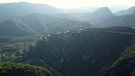 aerial: the road leading to papingo village in the zagori region of epirus, greece, features multiple twists and turns