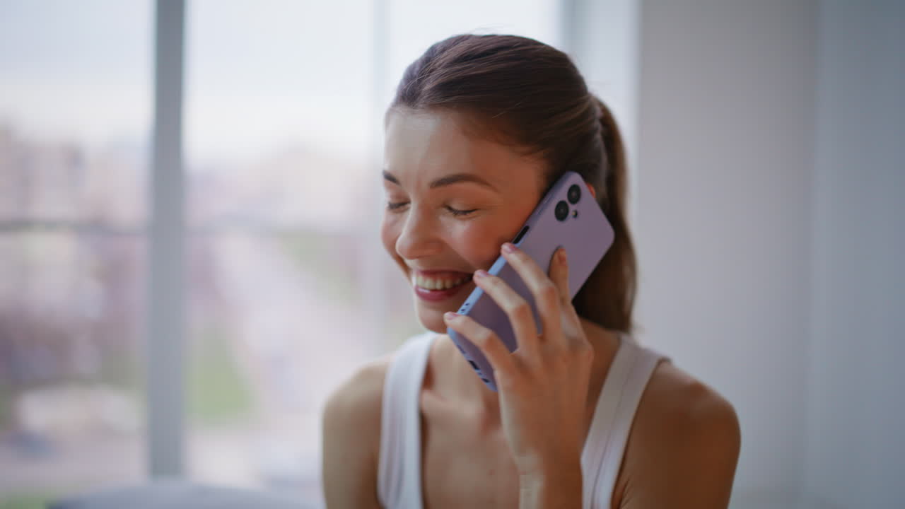 Laughing lady speaking mobile phone resting bedding closeup. Happy woman calling