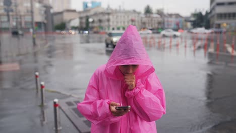 woman using smartphone in the rain