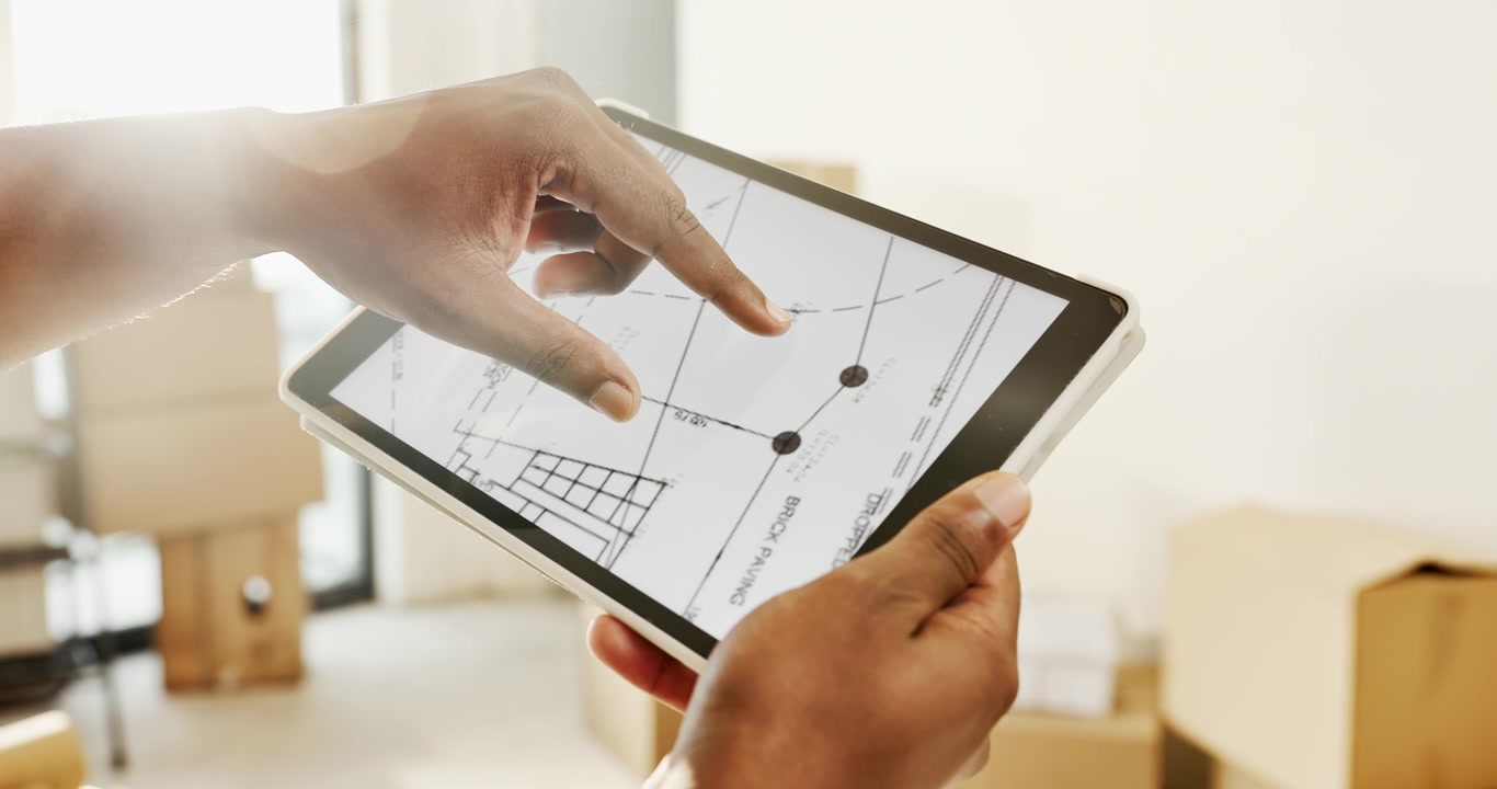 Architect Reviewing Construction Blueprints on a Digital Tablet
