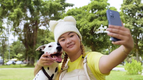 woman taking selfies with dog