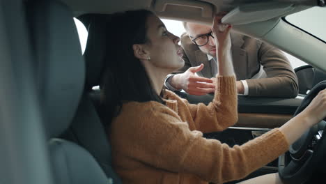 woman and salesperson discussing car features