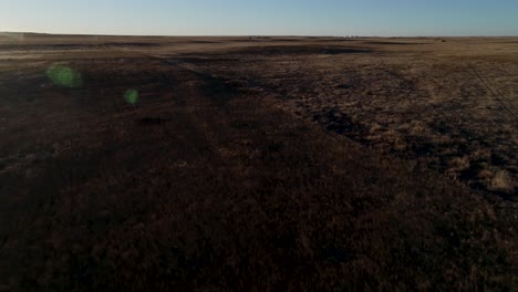 a lens flare during a sunset grasslands flyover in eastern colorado