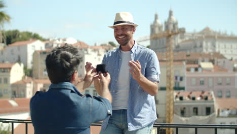 Gay-kneeling-and-proposing-to-his-excited-lover-outdoors-on-summer-day