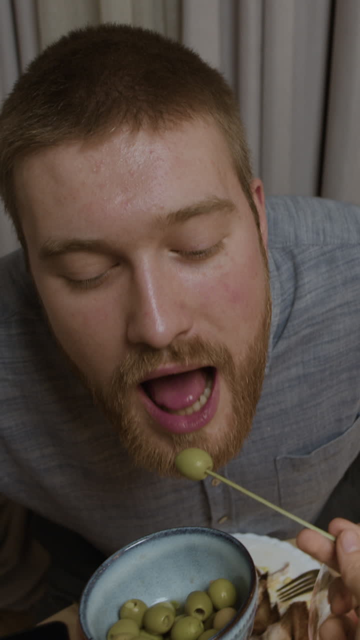 Man eating olives